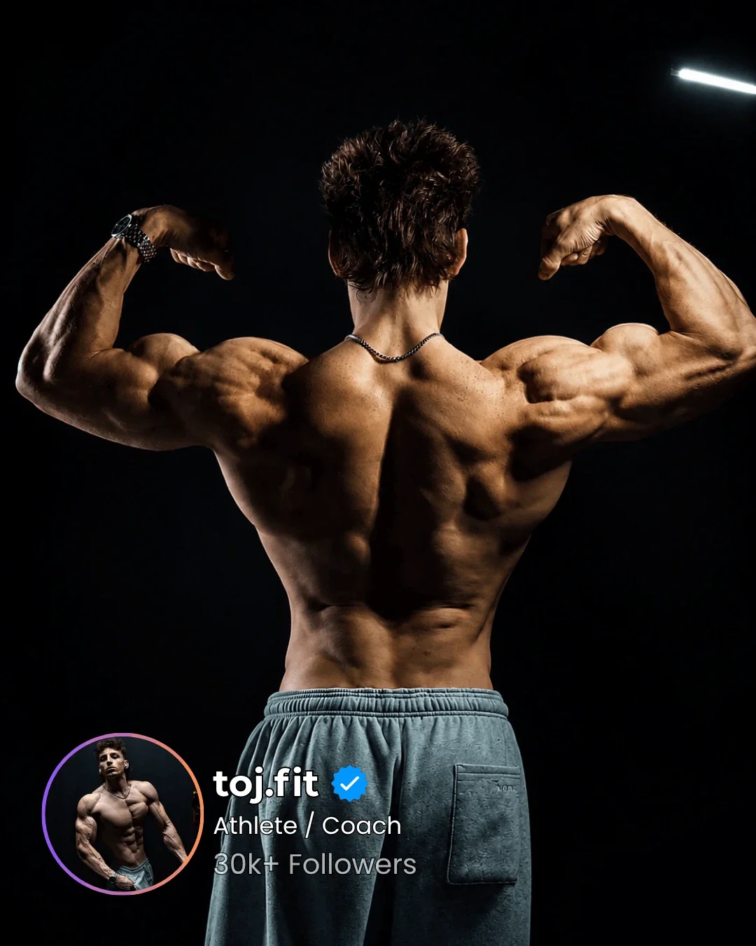 Athlete in a back double bicep pose, back muscles raked by a light bar on the rack